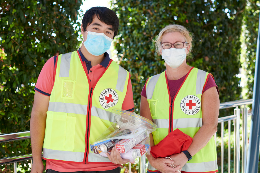 Two Red Cross workers wearing surgical face masks