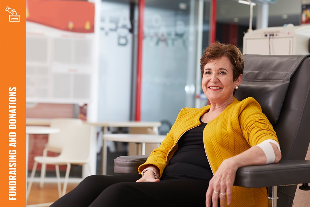 Lady smiling in a chair after a blood donation