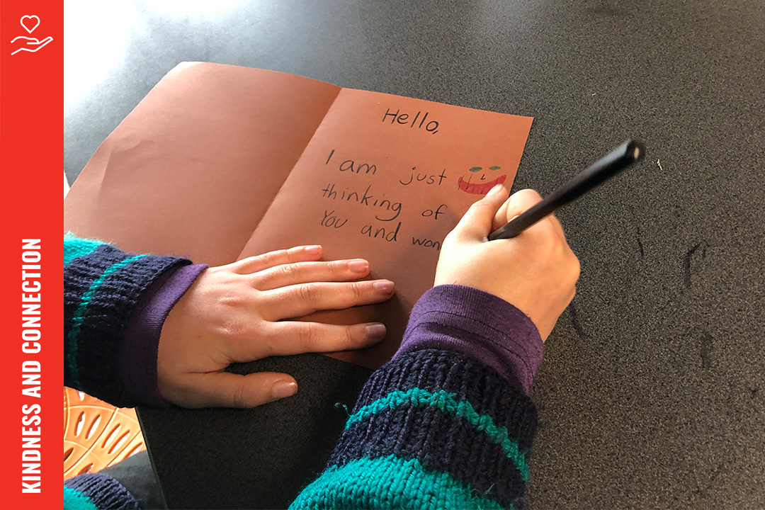 Person writing on a card