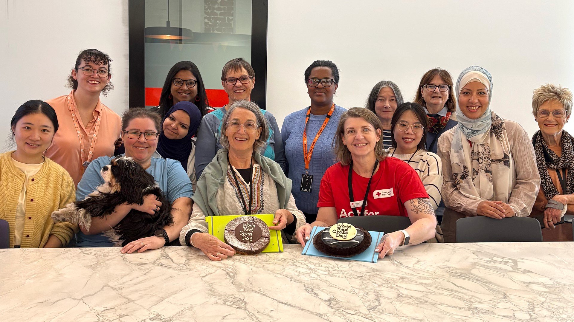 Three women, all Members od Red Cross, smile in a group photo